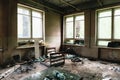 Room with big windows and furniture in old ruined abandoned building Royalty Free Stock Photo