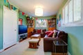 Room with bookcase decorated with colorful flags