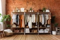 A room with a brick wall and a clothes rack in fashion studio workshop