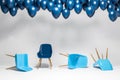 Room with chairs lying and one standing, balloons