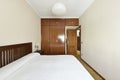 Room with classic wooden furniture with built-in wardrobe with wooden trunks and matching door Royalty Free Stock Photo