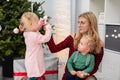 Blonde woman with glasses plays with two small children Royalty Free Stock Photo
