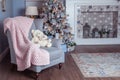 Room decorated for the new year, in soft pastel colors, cute bears in an armchair. Christmas mood