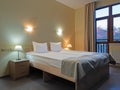 Room with a double bed with table and wall lights and a mountain view from the window Royalty Free Stock Photo