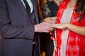 Newlyweds exchange rings, groom puts the ring on the bride`s hand in marriage registry office . The brides is wearing a ring on Royalty Free Stock Photo