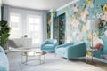 a room with a fresh wallpaper design in bold colors, complemented by pale blue walls and light furniture Royalty Free Stock Photo