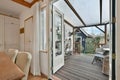 a room with a glass door open to a deck Royalty Free Stock Photo