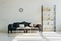 Room with grey sofa, clock, shelf and table with laptop in sunlight