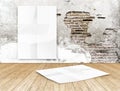 room with hanging blank crumpled white poster at crack brick wall and wooden floor room,Template Mock up for your content Royalty Free Stock Photo