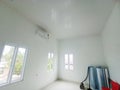 The room has a clean white nuance with a minimalist ceiling