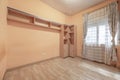 Room of a house with wooden floors, some loose furniture