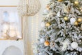 room interior with Christmas tree decorated with golden balls toys on blurred, sparkling and fabulous fairy tale background with Royalty Free Stock Photo