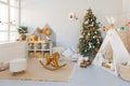 room interior with Christmas tree decorated with golden balls toys on blurred, sparkling and fabulous fairy tale background with Royalty Free Stock Photo