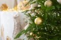 room interior with Christmas tree decorated with golden balls toys on blurred, sparkling and fabulous fairy tale background with Royalty Free Stock Photo