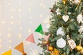 room interior with Christmas tree decorated with golden balls toys on blurred, sparkling and fabulous fairy tale background with Royalty Free Stock Photo