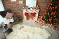 Room interior with Christmas tree and gifts near decorative fireplace Royalty Free Stock Photo