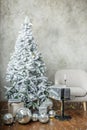 Room interior with Christmas tree, gray chair and gift boxes. Copy space Royalty Free Stock Photo