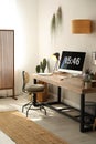 Room interior with comfortable workplace. Modern computer on wooden desk Royalty Free Stock Photo