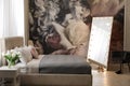 Room interior with large bed, mirror and floral pattern on wall Royalty Free Stock Photo