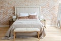 A room in light loft stile with brick wall and light furniture.