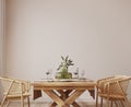 Room mockup in Scandinavian dining room design, rattan chairs and wooden dining table on bright beige interior background Royalty Free Stock Photo