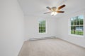 Room in a newly constructed house with white walls, a lit chandelier, and glass windows Royalty Free Stock Photo