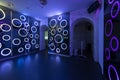 Room of a nightclub decorated with rgb led lights and accesses to other rooms with semicircular arches of white painted bricks Royalty Free Stock Photo