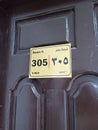 Room Number 305 Hotel in Madinah and 5 bed. Door wood with label Royalty Free Stock Photo