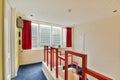 a room with red and white stairs and a window