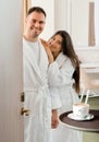 Room service delivering coffee to a hotel room for married couple wearing bathrobe Royalty Free Stock Photo