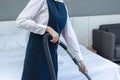 Room service maid cleaning a hotel room, chambermaid making bed in hotel room, Female housekeeper putting clean towels on bed Royalty Free Stock Photo