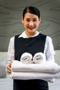 Room service maid cleaning and making bed hotel room concept, portrait of young beautiful Asian smiling female chambermaid holding Royalty Free Stock Photo