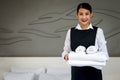 Room service maid cleaning and making bed hotel room concept, portrait of young beautiful Asian smiling female chambermaid holding Royalty Free Stock Photo