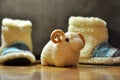 Room slippers are on the floor and a toy ram stands next to it. Royalty Free Stock Photo