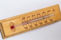 room thermometer on a wooden base close up on a white background. Celsius degree scale Royalty Free Stock Photo