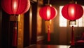 In the room three traditional Chinese red paper lanterns hang next to the window