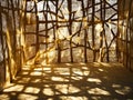 A room with a tree-like structure made out of burlap and sunlight shining through it Royalty Free Stock Photo
