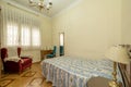 Room with vintage and gaudy-looking furniture and bed