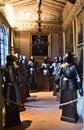 Room with window, with paintings on the walls and ten medieval armours, of the ancient villa Stibbert in Florence.