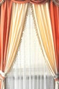 Room window with white, yellow and orange curtains Royalty Free Stock Photo