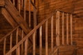 Room with wooden stairway leading to second floor of modern flat. Modern staircase with wooden steps Royalty Free Stock Photo