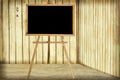 Room with wooden wall and blackboard Royalty Free Stock Photo