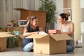 Roommates talking unboxing gelongings moving home