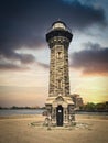 Roosevelt Island Lighthouse also known as Blackwell or Welfare. Lighthouse made of stones. View during stormy sunset