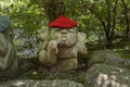 Rooster - symbol of japanese horoscope. Jizo stone statue wearing knitted and cloth hats.