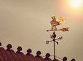 Rooster weather vane on sunset Royalty Free Stock Photo