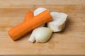 Root vegetables for soup. Carrots, parsley, celery, onions on a wooden cutting board Royalty Free Stock Photo