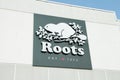 tor, canada - august 10, 2023: roots est 1973 sign logo on front of store facade with picture illustration. p Royalty Free Stock Photo