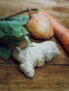 Roots garlic, onion, carrot, bay leaf lying on a wooden table Royalty Free Stock Photo