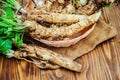 Roots of young horseradish on a wooden background. Royalty Free Stock Photo